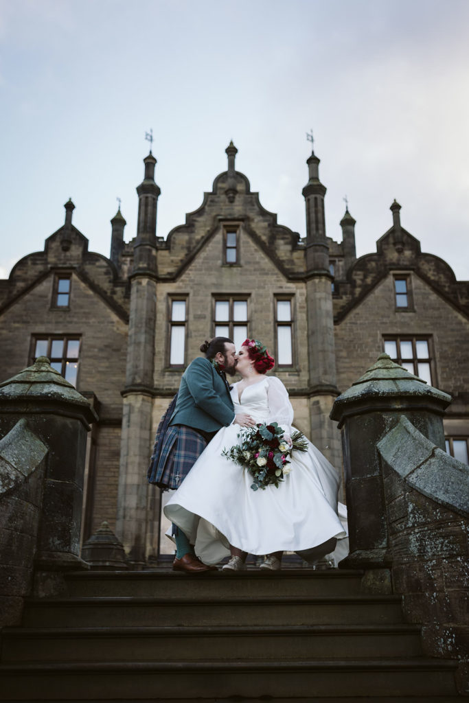 The happy couple kiss during their photoshoot on a chilly December day