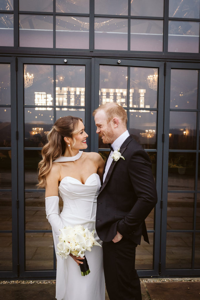 Bride and groom in black tie outside Wharfedale Grange wedding venue in Yorkshire