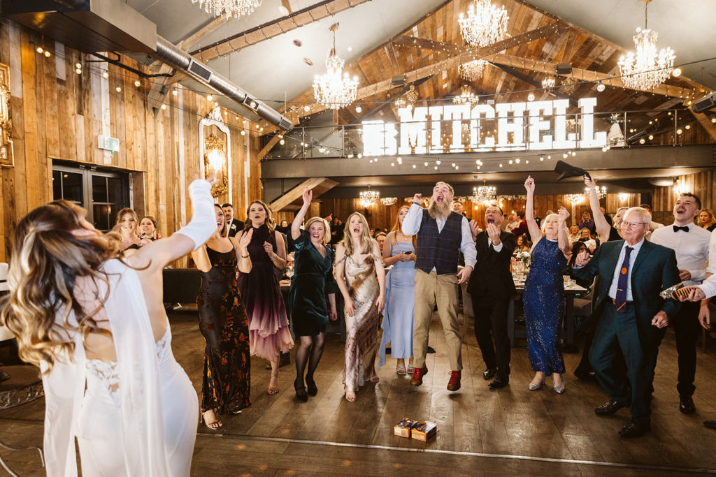 The Bride throws Jaffa Cakes at her guests during the Bongo Bingo section of their wedding.