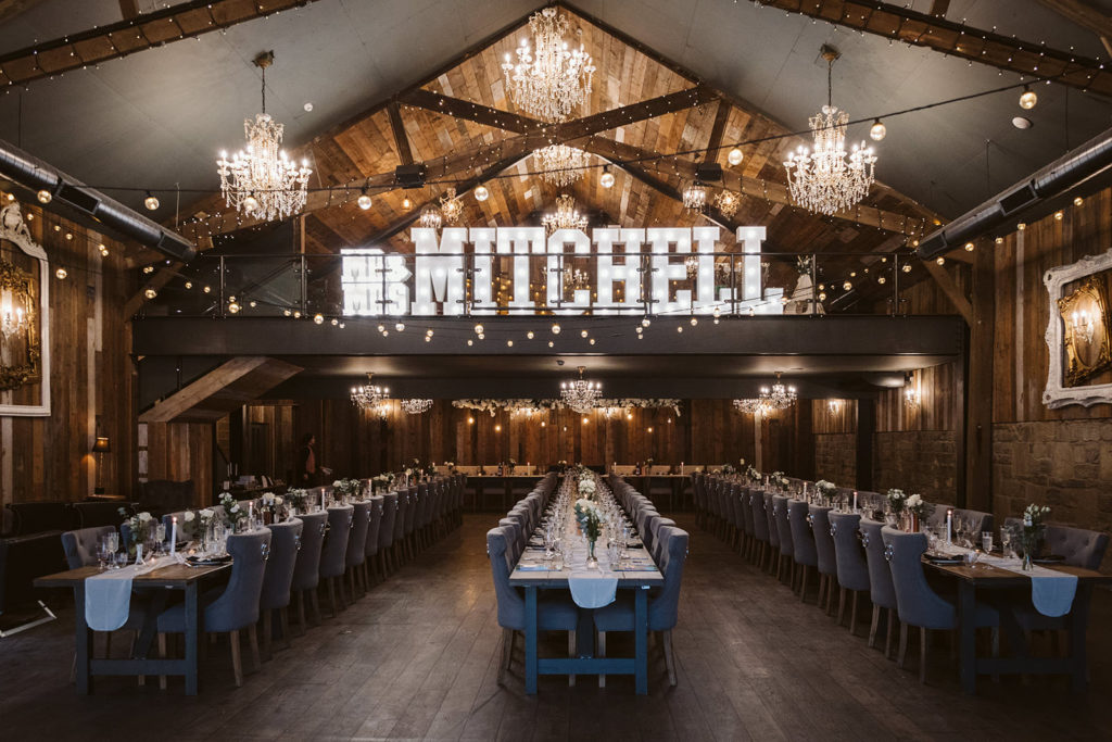 Wedding Breakfast set up with the couples name in light up letters at this Luxury Barn Wedding venue in North yorkshire