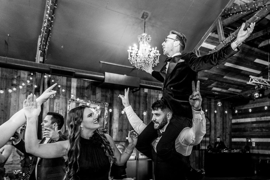 : Guests dancing on chairs during Bongo Bingo at a Wharfedale Grange wedding