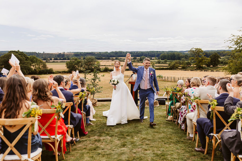 Bride and groom surrounded by family and friends during their ceremony