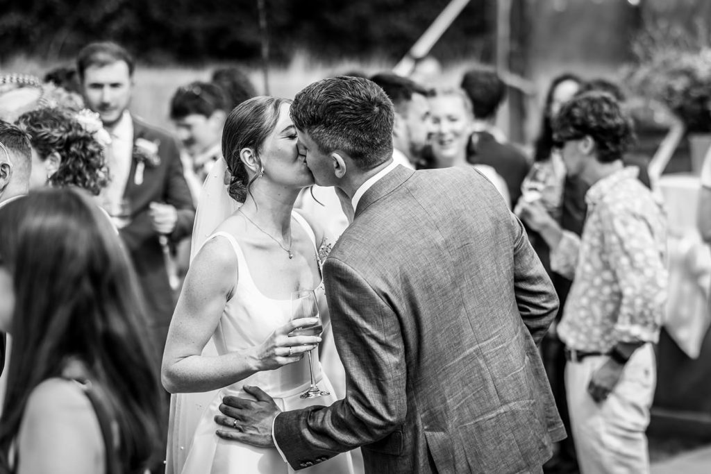 Hester and Chris celebrating with friends outside their wedding marquee