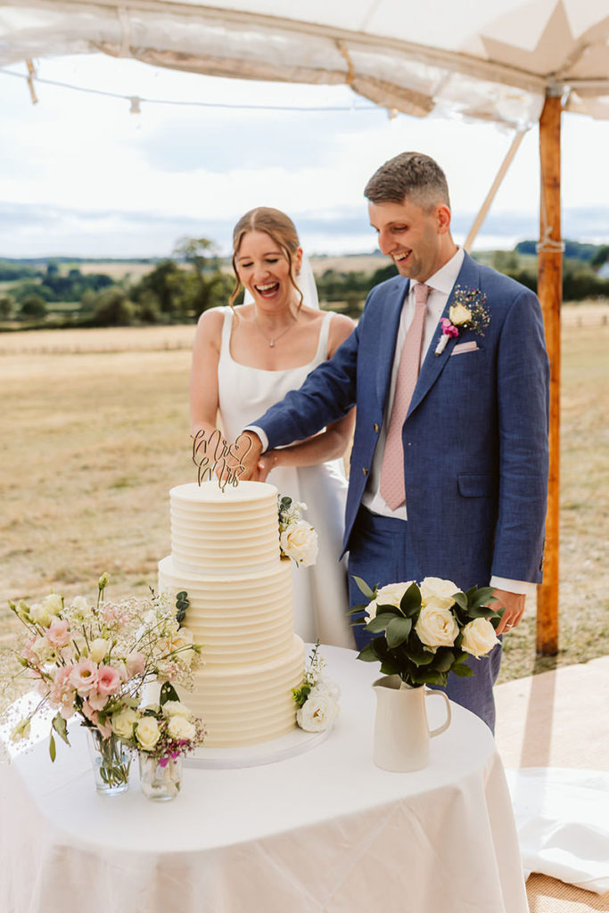 The Bride and Groom cut their cake in front of views of the North Yorkshire Countryside