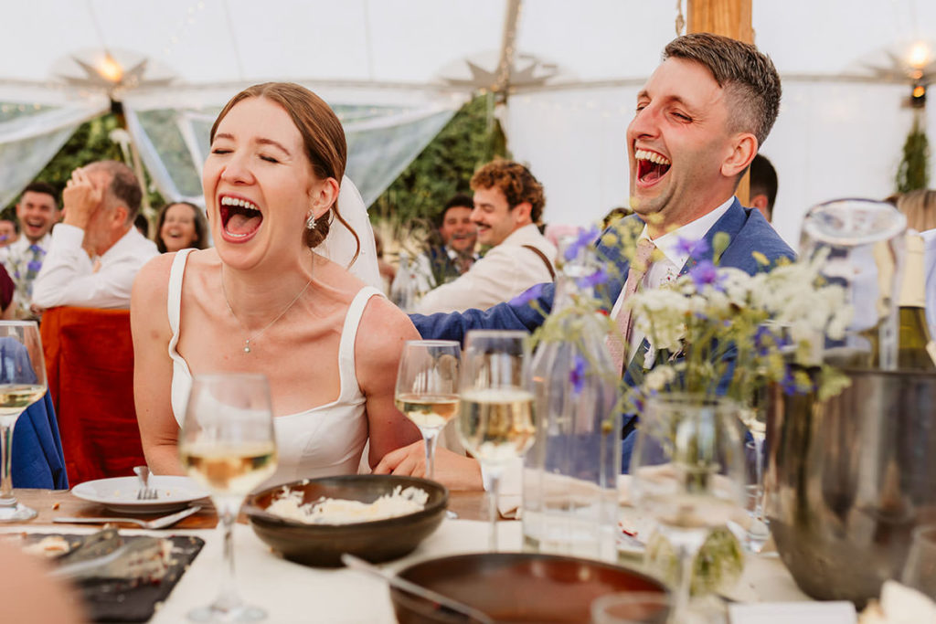 Hester and Chris reacting to speeches at their wedding reception