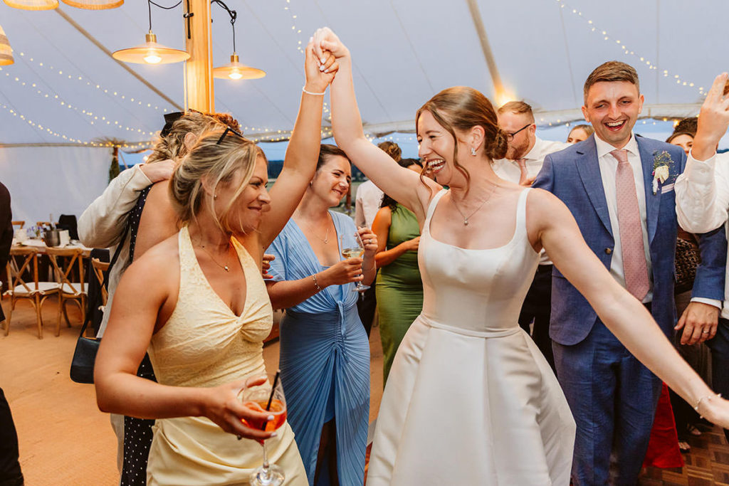 Guests celebrating on the dance floor at a family home wedding