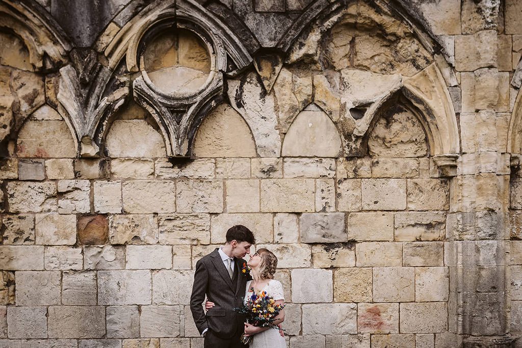 A newlywed couple being put at ease by Hannah Brooke Photography during their couple portraits