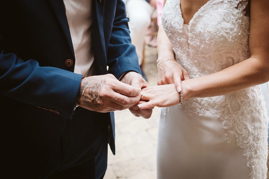 Nat and Martin exchanging rings at their May wedding in Spofforth