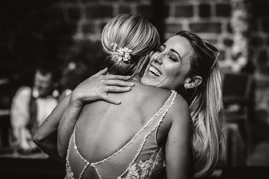 A guest hugs the bride
