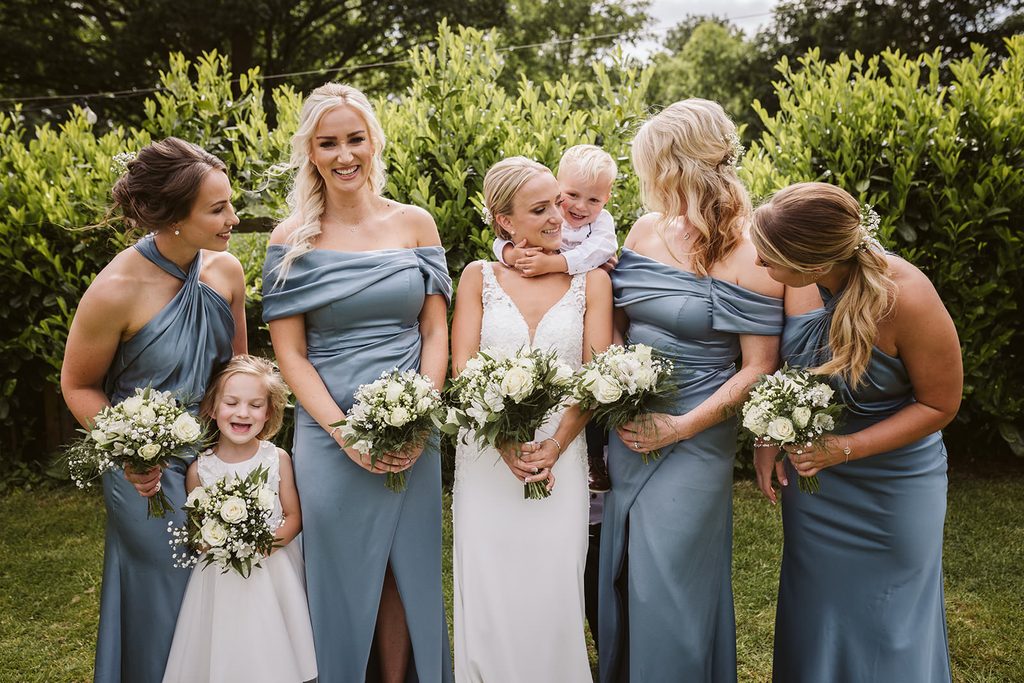 Wedding guests laughing together during the outdoor celebrations in Spofforth