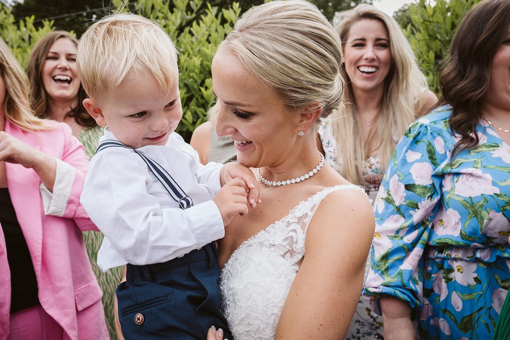 The bride gives her son a hug