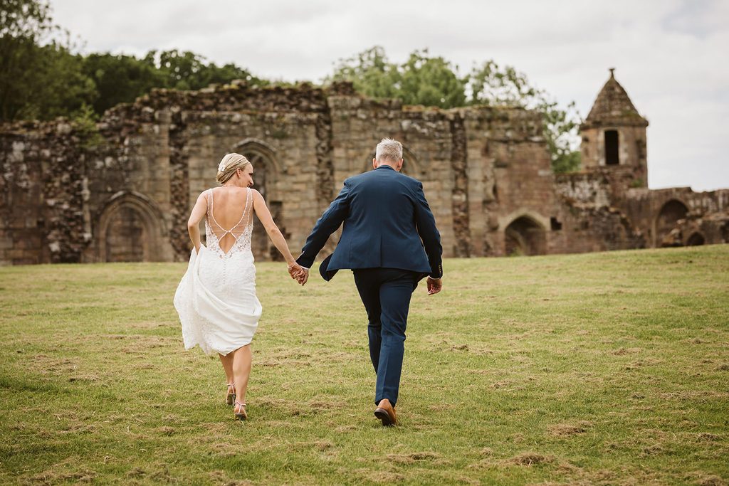 Nat and Martin walking beside the castle ruins in Spofforth
