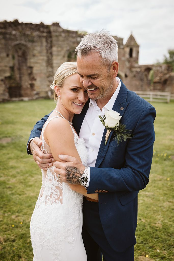 Nat and Martin laughing during their wedding portraits at Spofforth Castle