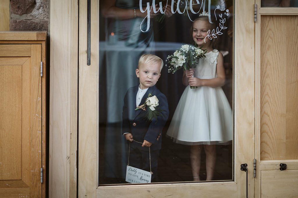 The bride and groom's children wait patiently to walk down the aisle